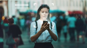 Privacy By Design - Woman holding phone in a secure browser preventing unwanted facial recognition.