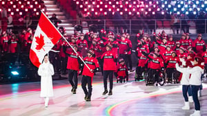 Group of Paralympic athletes at Pyeong Chang 2018 opening ceremony waving Canadian flag