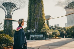 University student in graduation gown outside in university campus yard